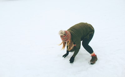 woman in snow field evergreen teams background