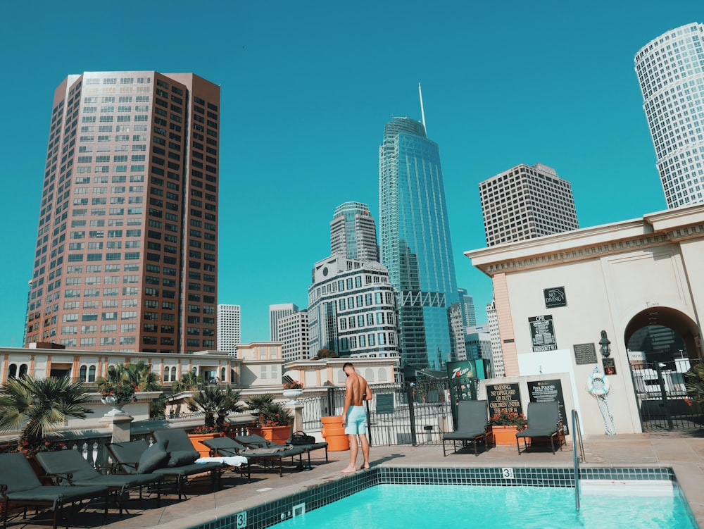 man standing beside pool