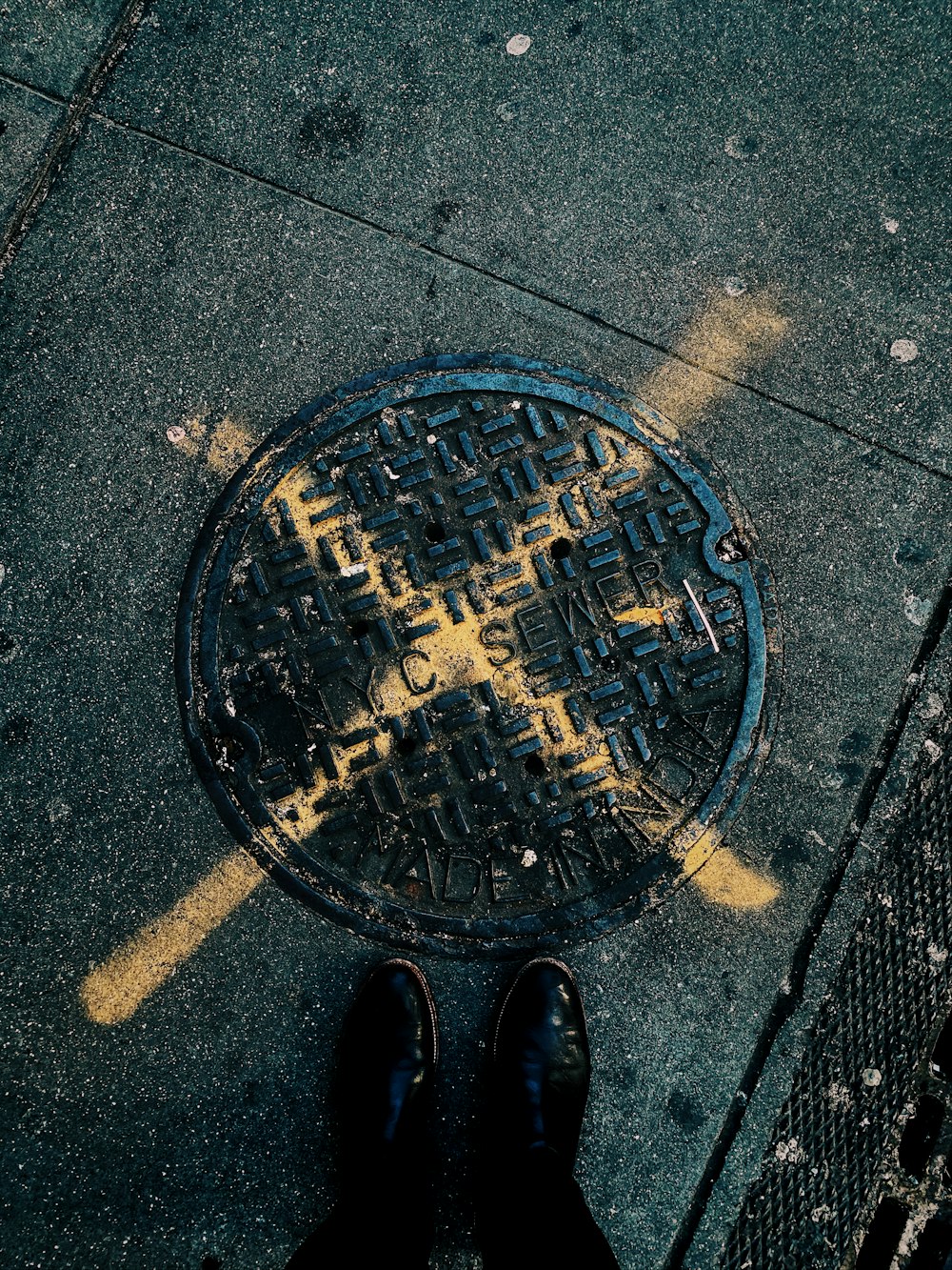 a manhole cover with a cross on it