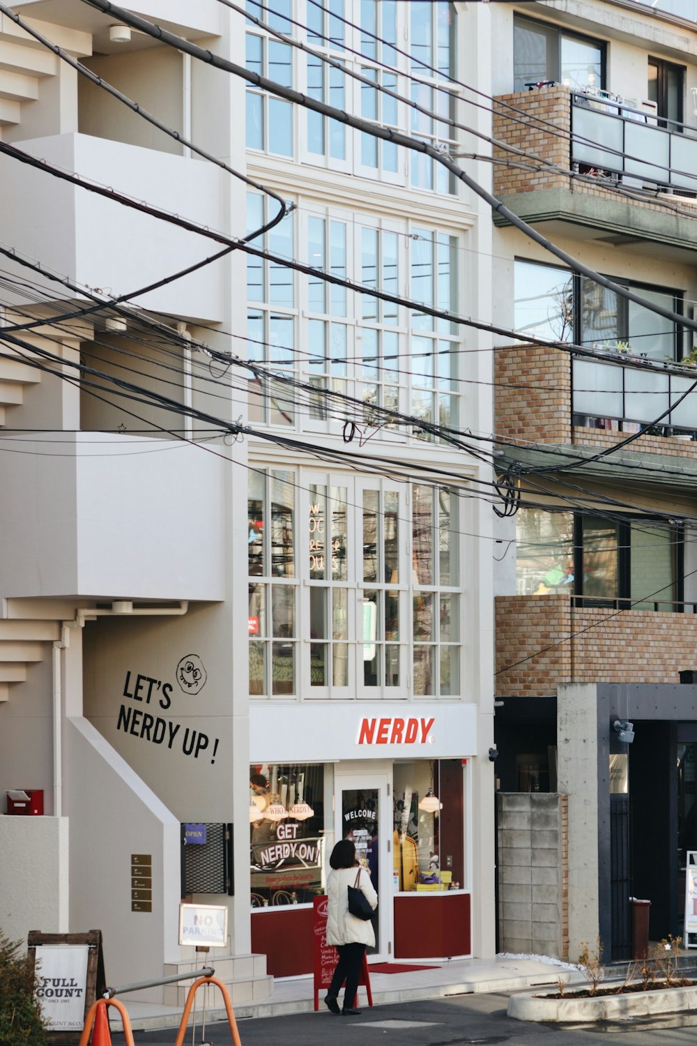 woman walking beside building