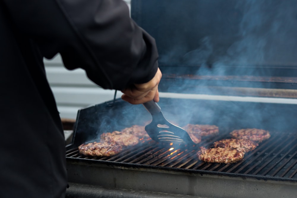 person grilling patty