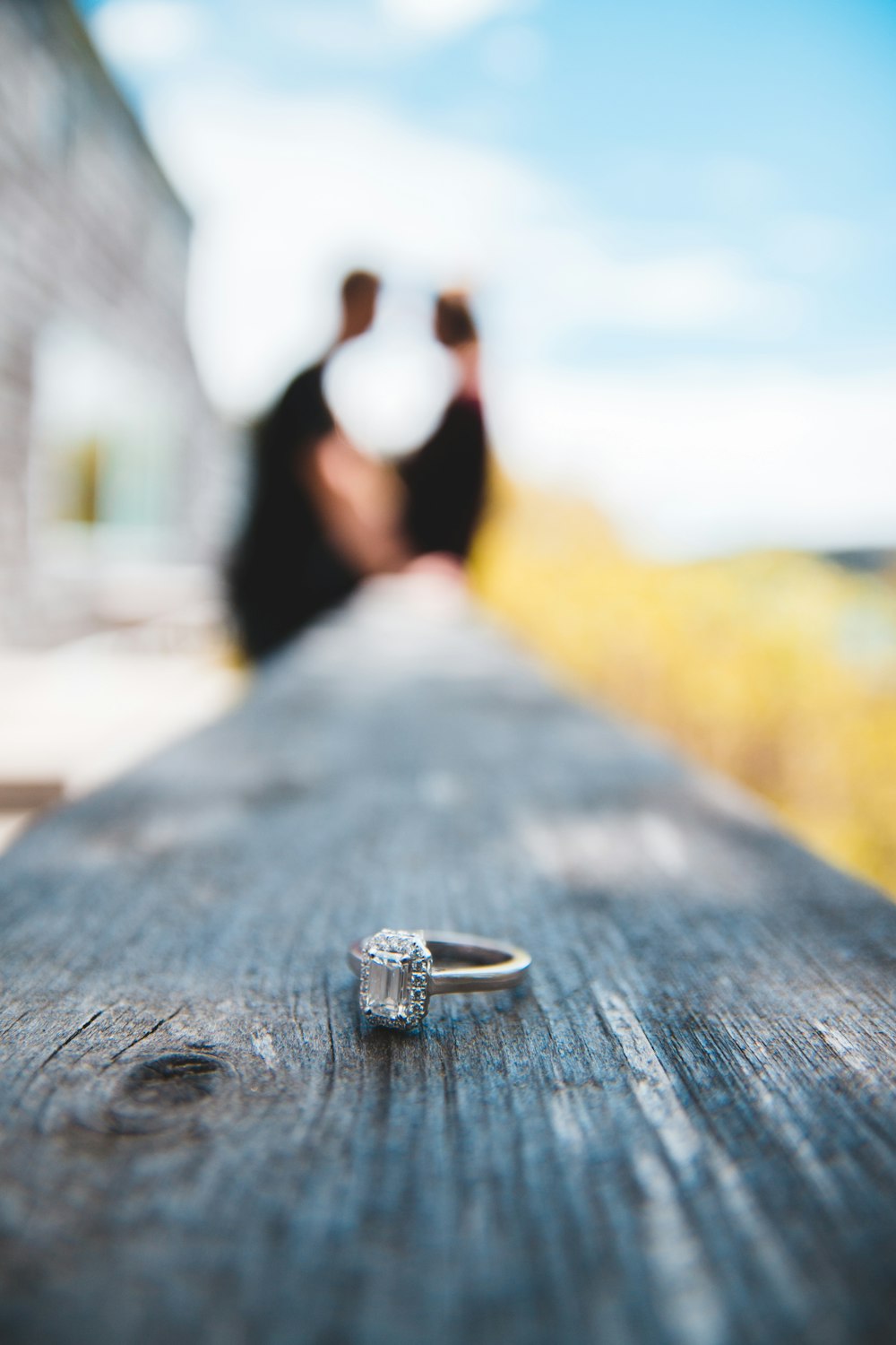 gold-colored ring on wooden fence