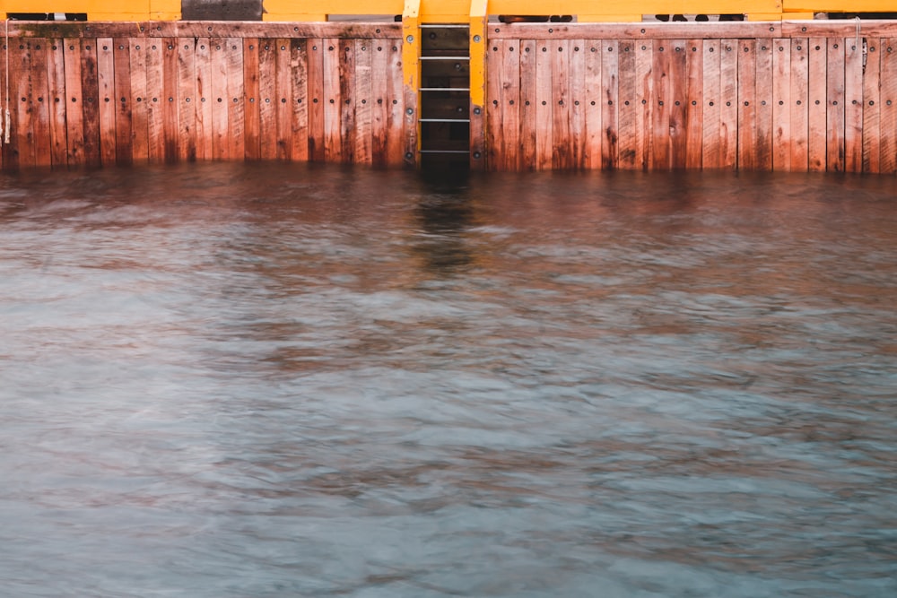 brown wooden port near body of water