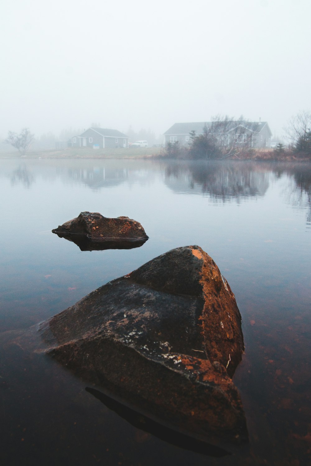 a large rock in the middle of a body of water