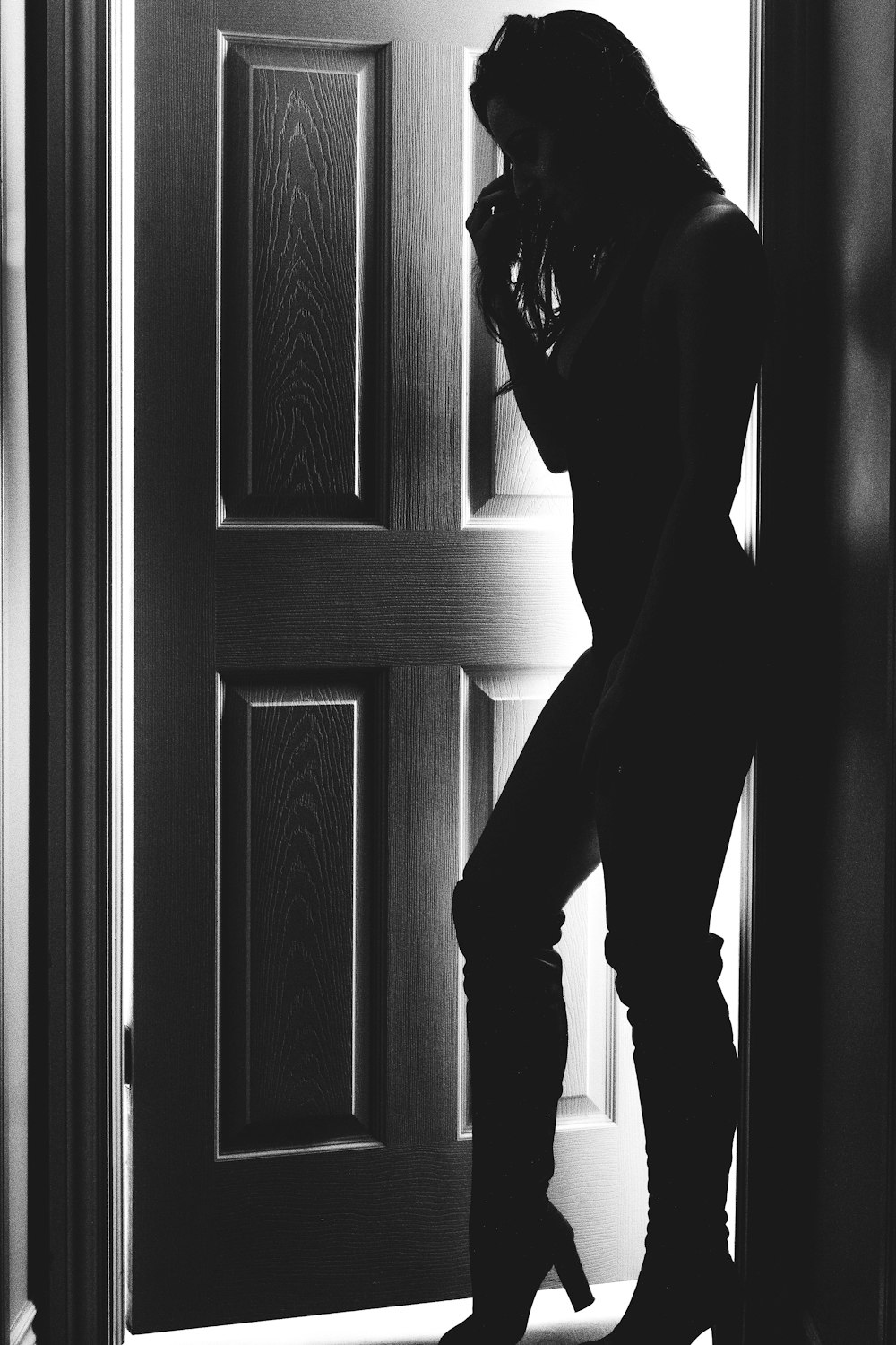 silhouette of woman standing on doorway