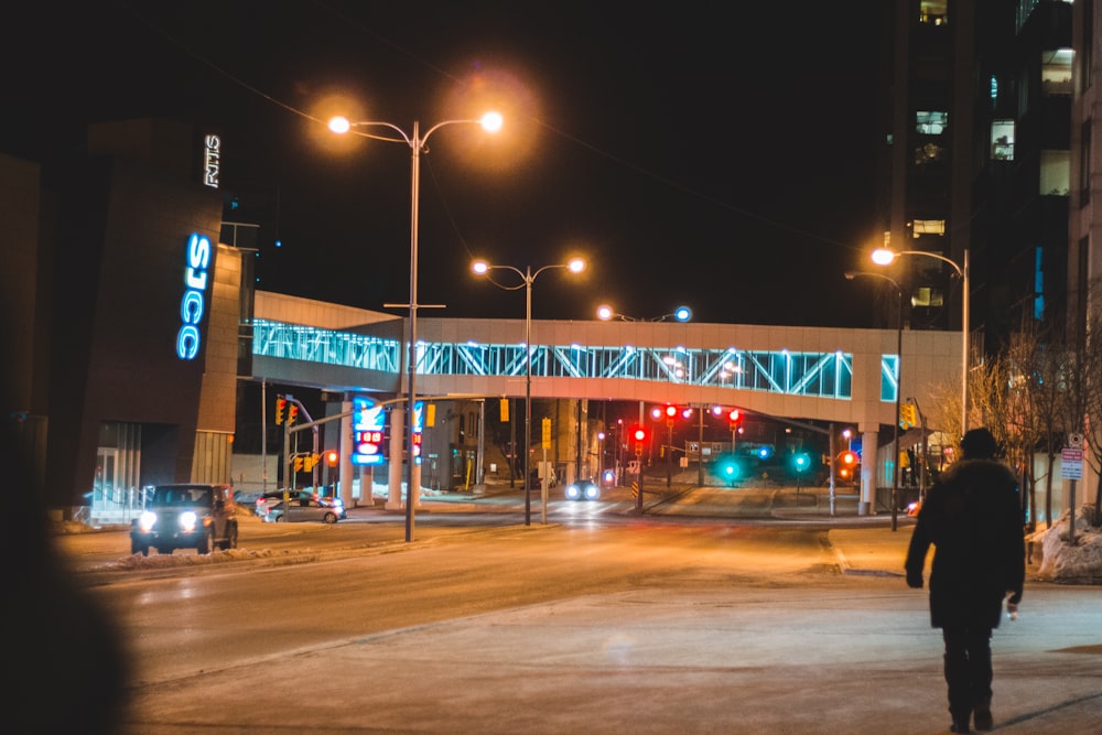 person walking on sidewalk at night