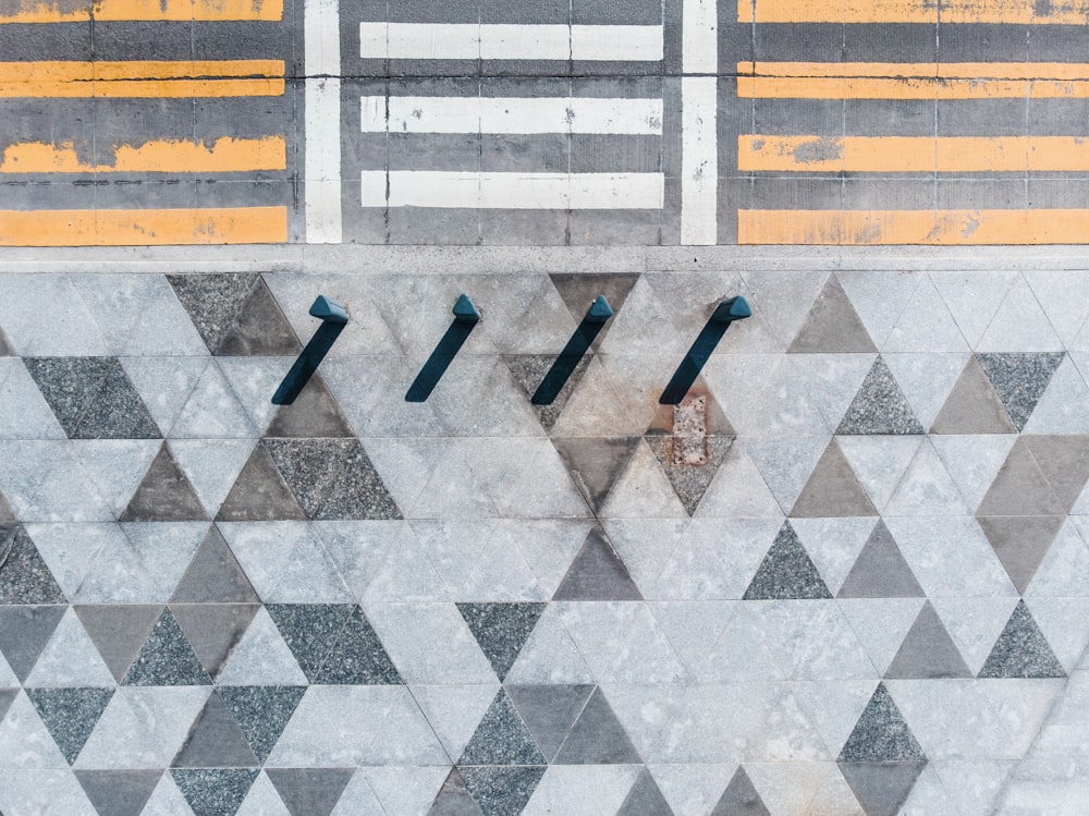 an overhead view of a tiled floor with arrows pointing in different directions