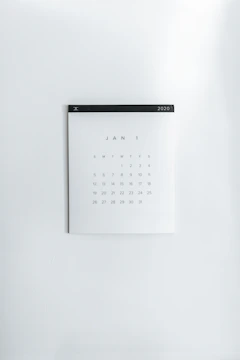 A plain white calendar on a wall