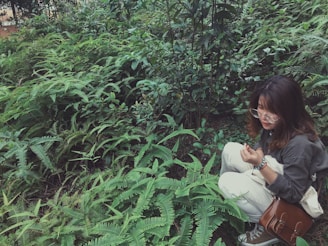A professional woman examining electromagnetic waves in a natural home setting surrounded by greenery.