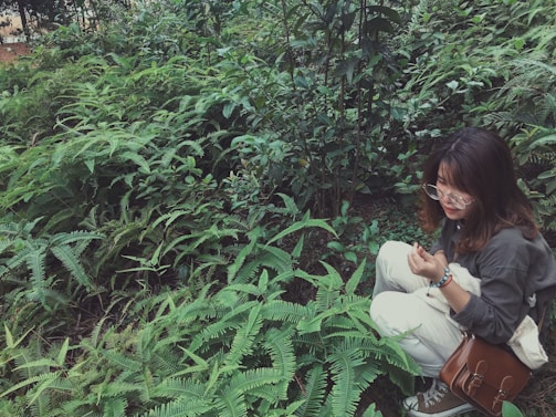 A professional woman examining electromagnetic waves in a natural home setting surrounded by greenery.