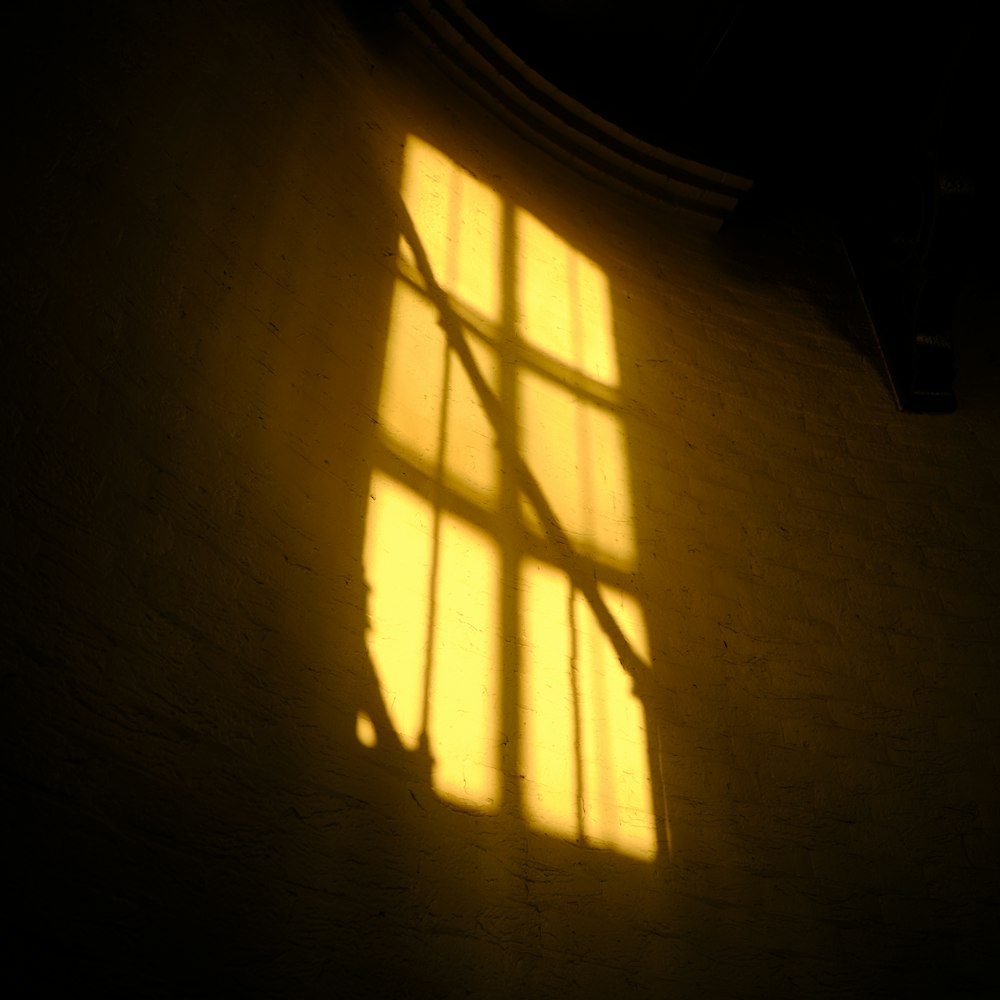 a shadow of a person standing in front of a window