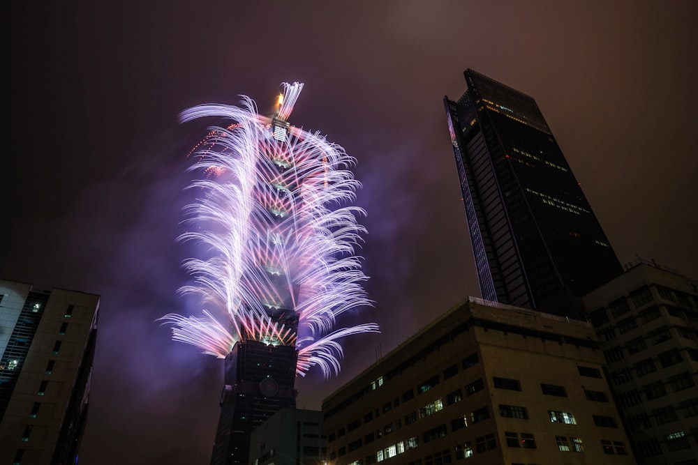 photography of fireworks on building during nighttime