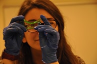 A playful scene showing slime being pulled apart between two fingers.