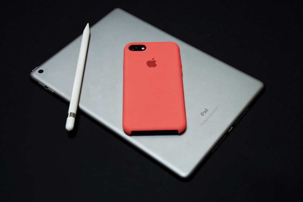 black iPhone with red case