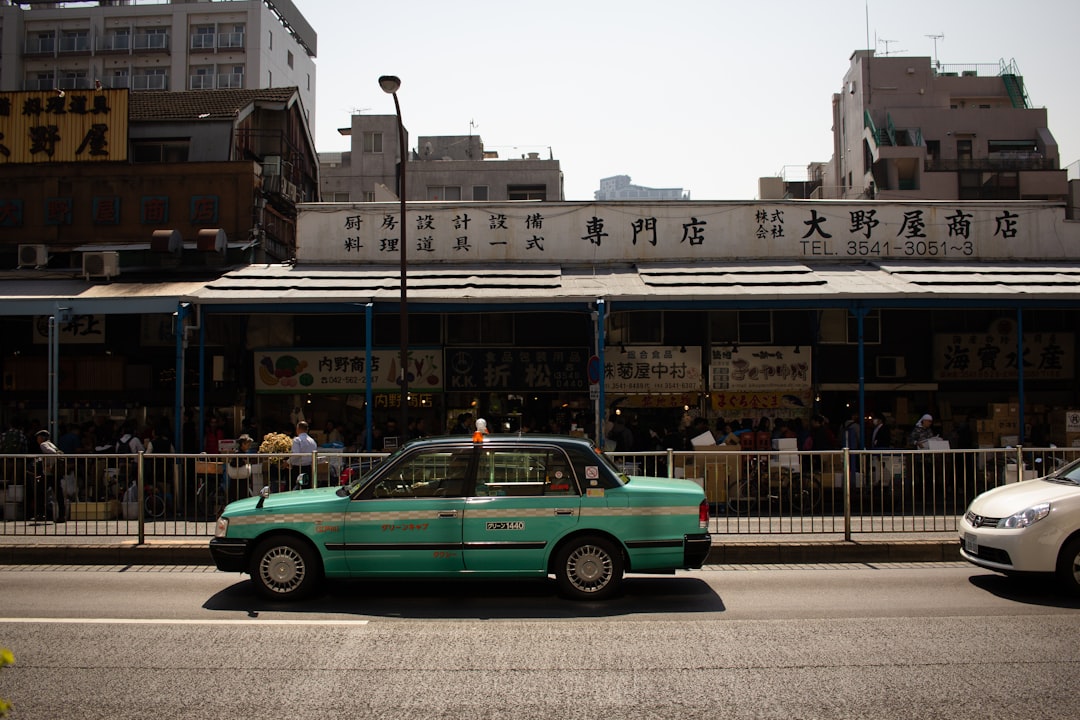 blue sedan on road during dayime