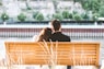 couple sitting on wooden bench