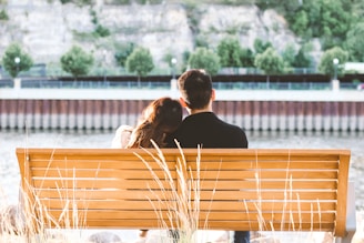 couple sitting on wooden bench