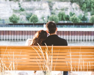 couple sitting on wooden bench