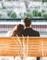 couple sitting on wooden bench