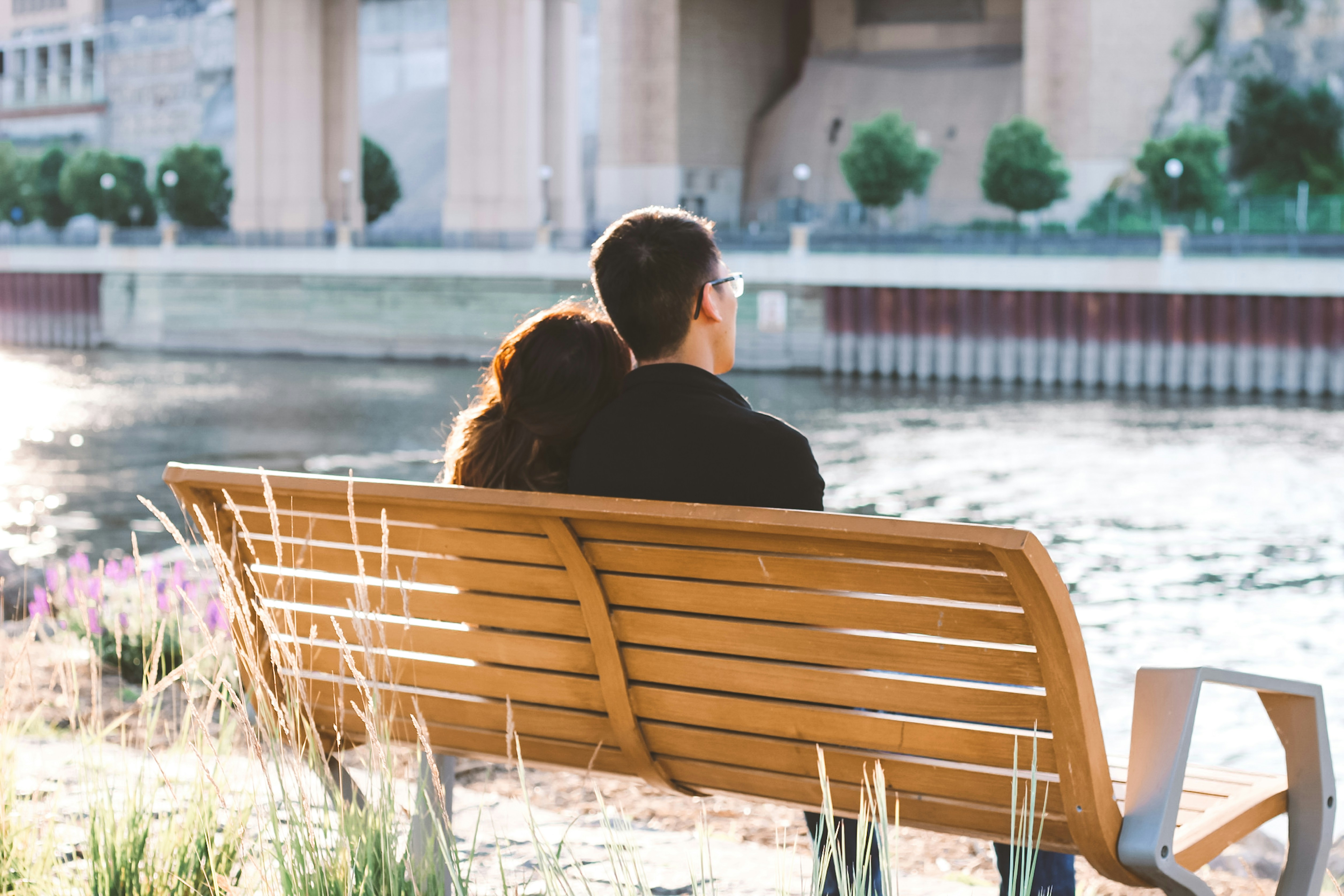 a couple sitting apart, looking distant - trauma informed marriage counseling