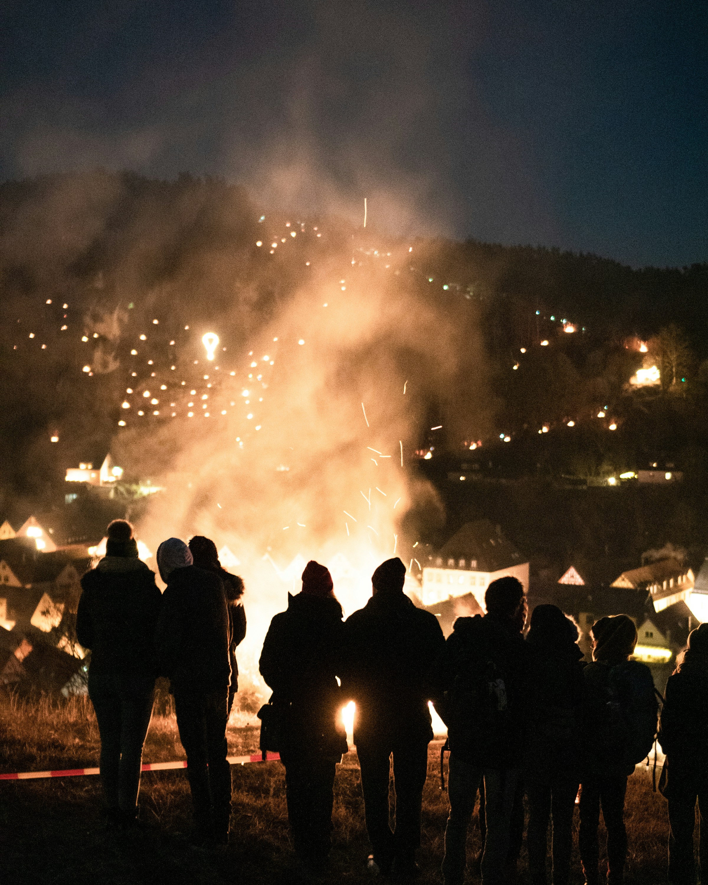 silhouette of people in front of mountains during nighttime