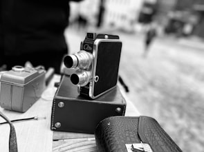 A premium camera with accessories on a table.