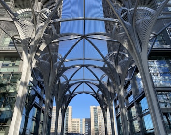 A wide-angle view of a sleek metal canopy structure installed outdoors, showcasing clean welds and modern design.