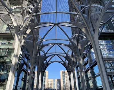 A sleek commercial canopy with membrane structure shading a modern storefront.