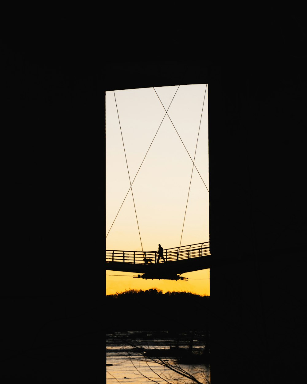 silhouette of person on hanging bridge
