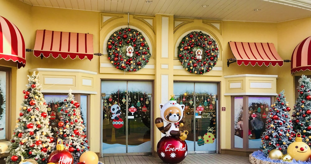 raccoon statue outside building with christmas decors