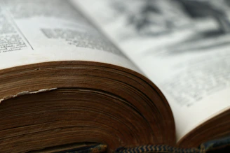 An open book with yellowed pages and a vintage map visible inside.