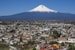 cityscape and volcano under blue sky