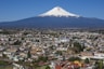 cityscape and volcano under blue sky