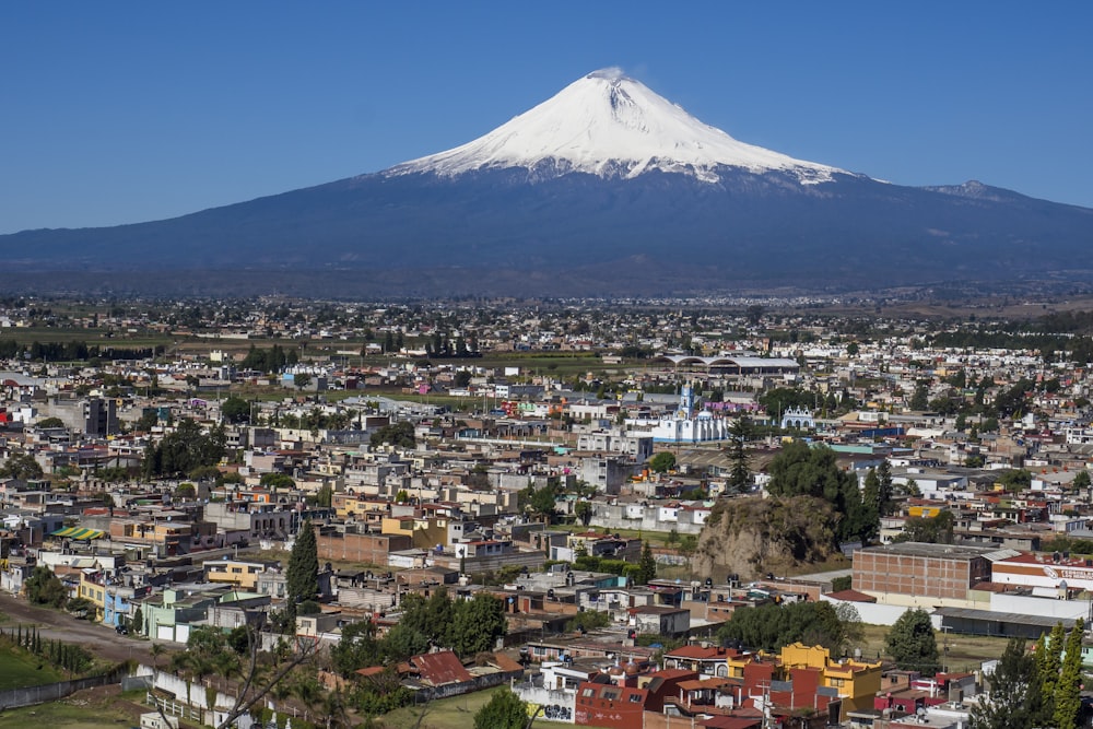 cityscape and volcano under blue sky