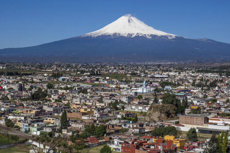 La ciudad con el volcán al fondo bajo cielo azul