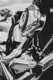 A close-up shot of a motorcycle engine with chrome details shining in the sun.