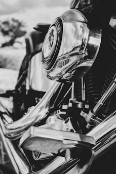 A close-up of a motorcycle engine with visible parts and tools around it.