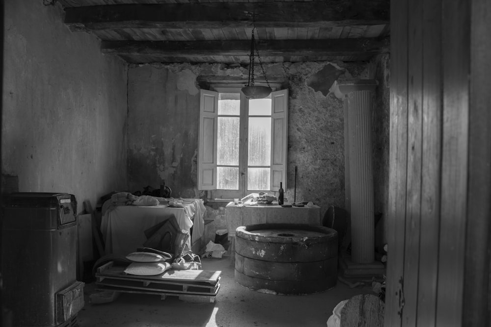 grayscale photo of table near window