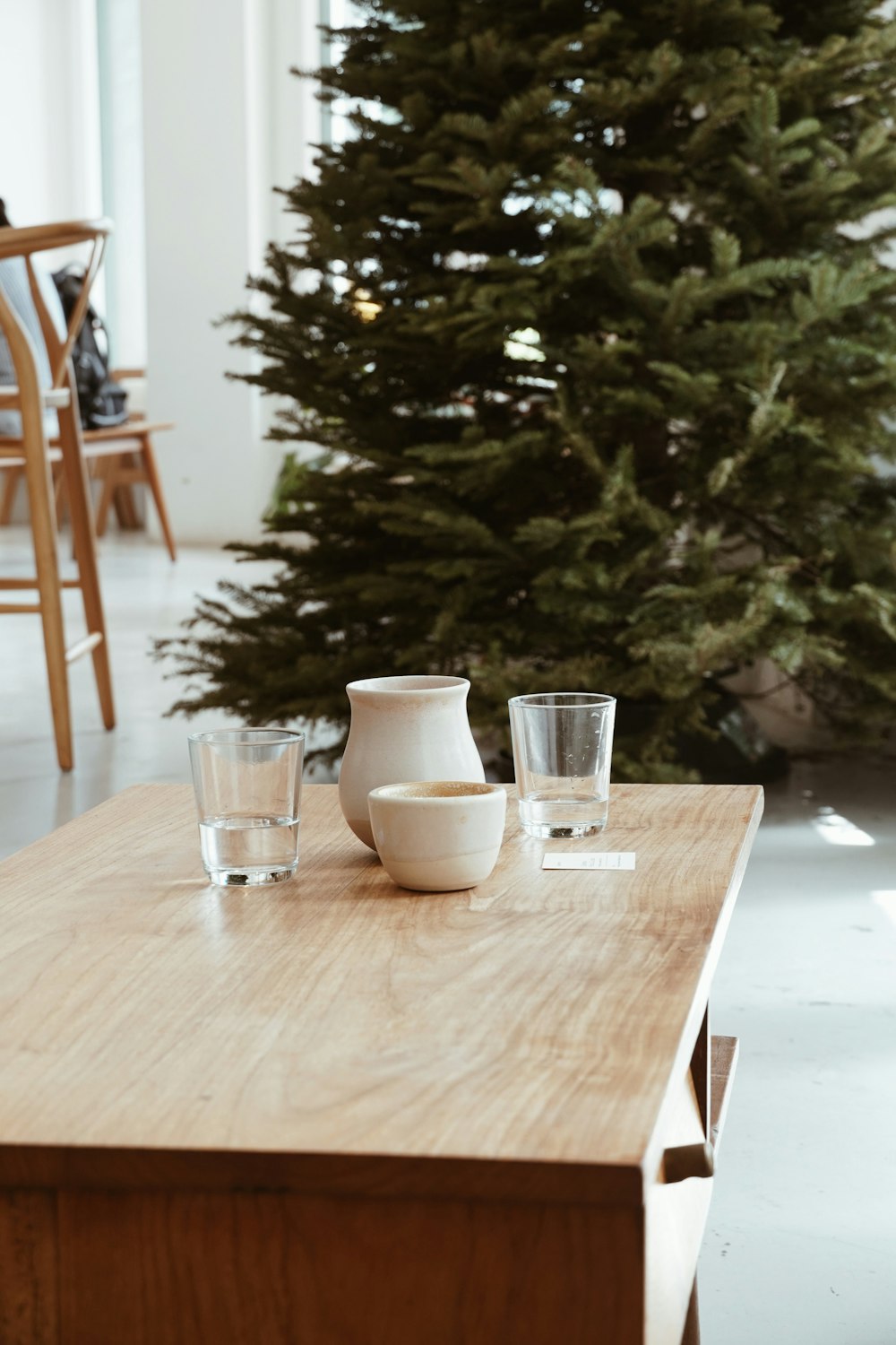 two clear drinking glasses on brown wooden table