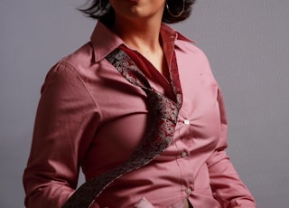 woman in pink dress shirt and red floral necktie
