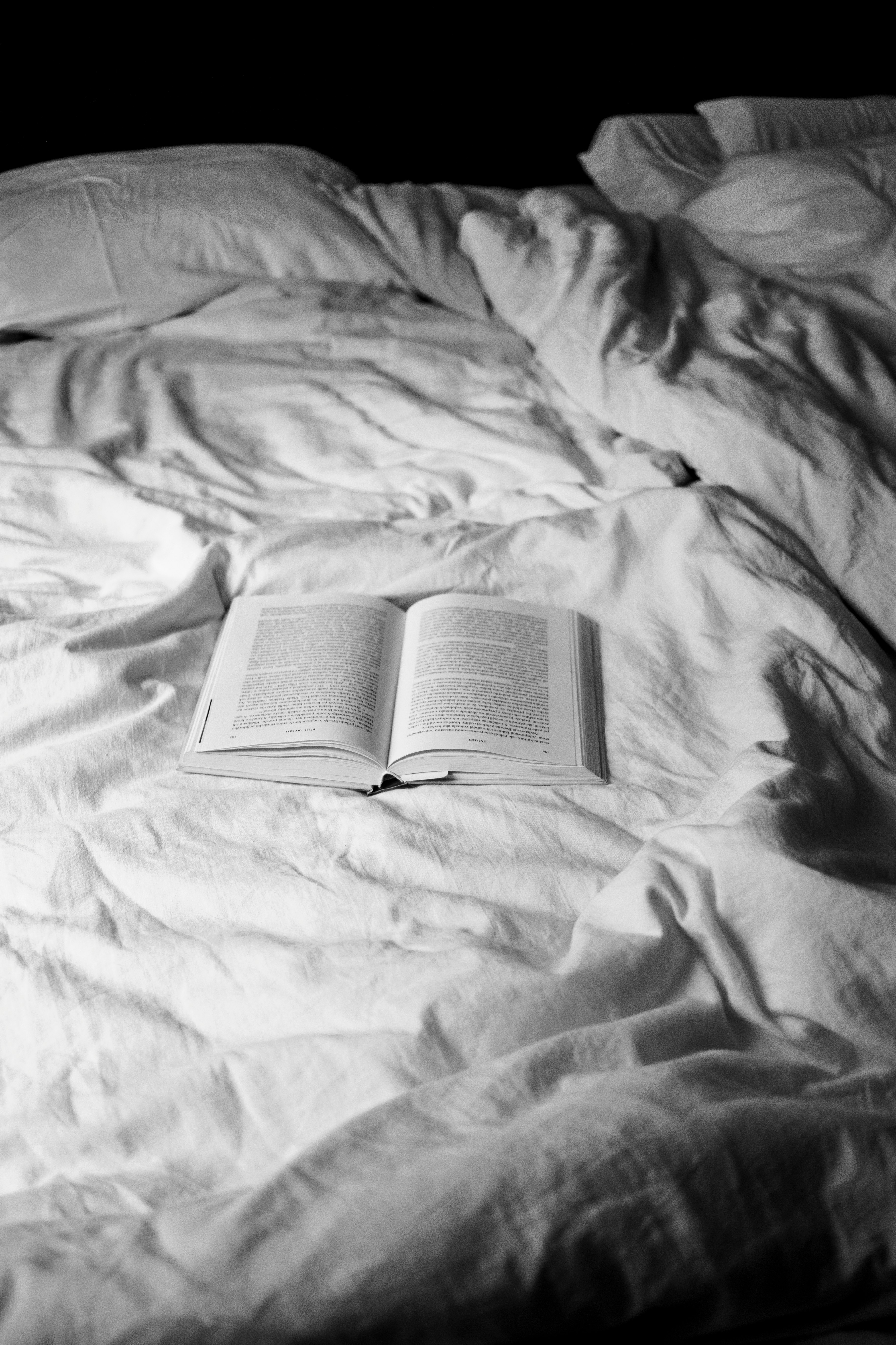 opened white book on bed