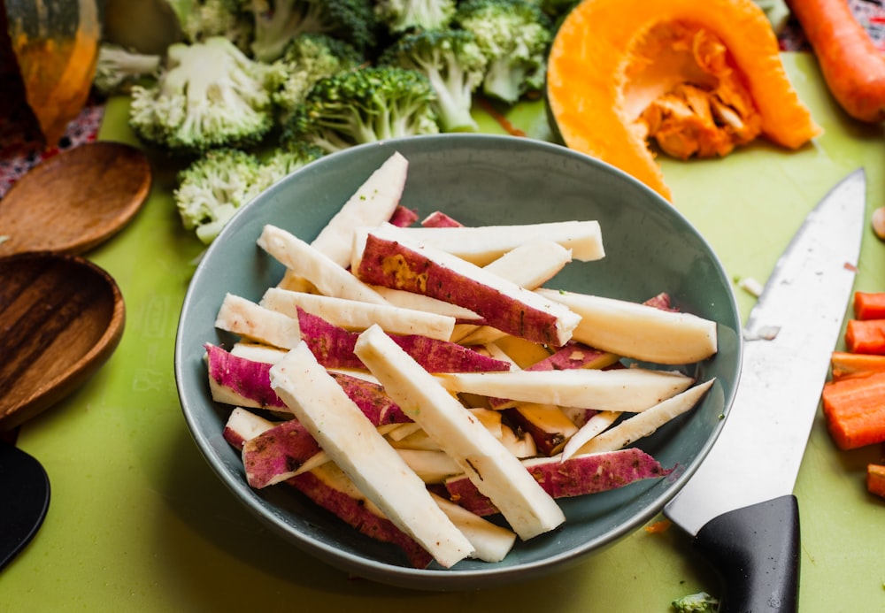 sliced vegetable on grey bowl