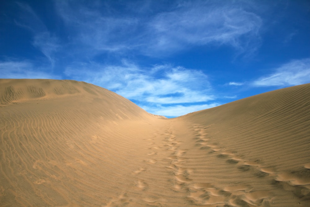 sand dunes under blue sky