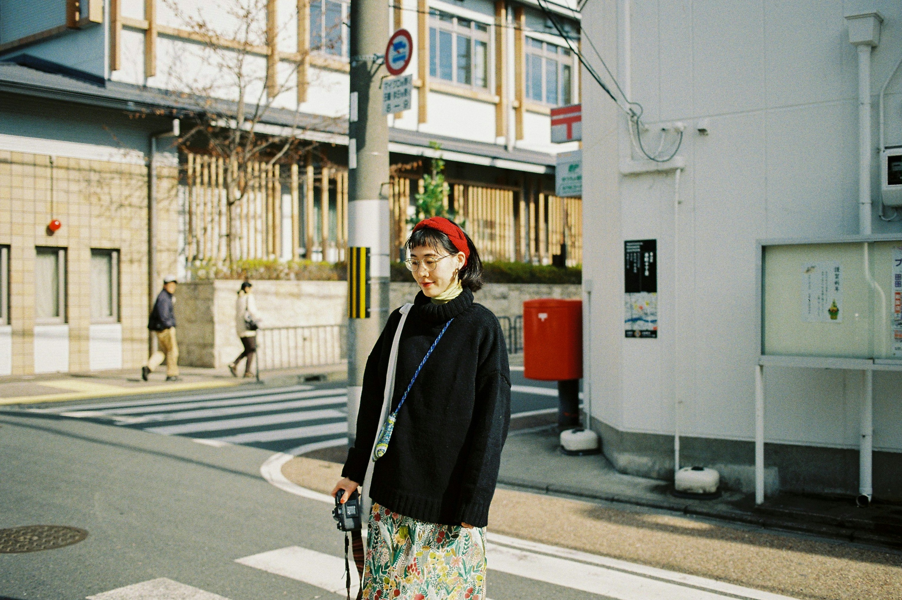 woman standing near white building