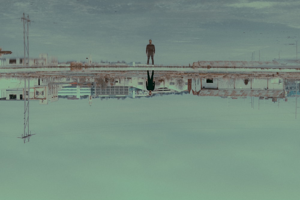 person standing in front of body of water during daytime