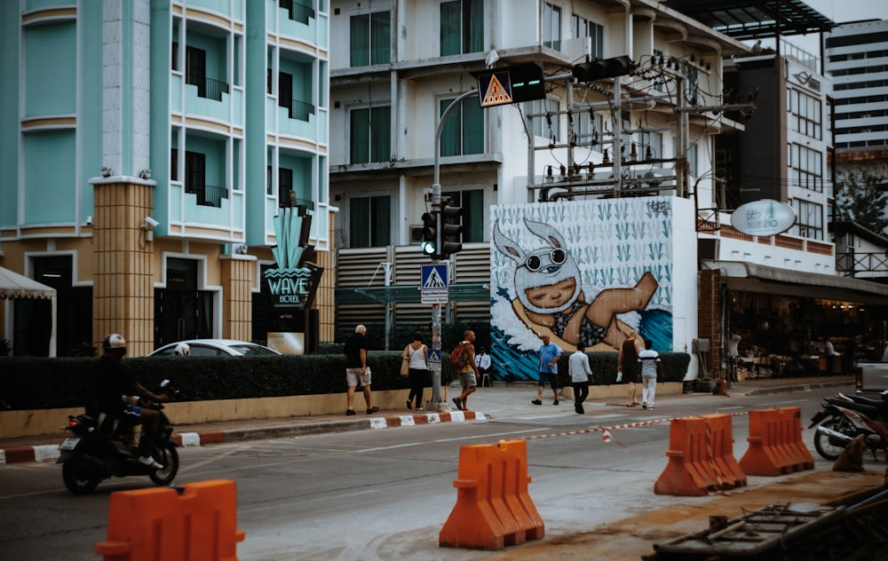 people walking on side walk in front of buildings