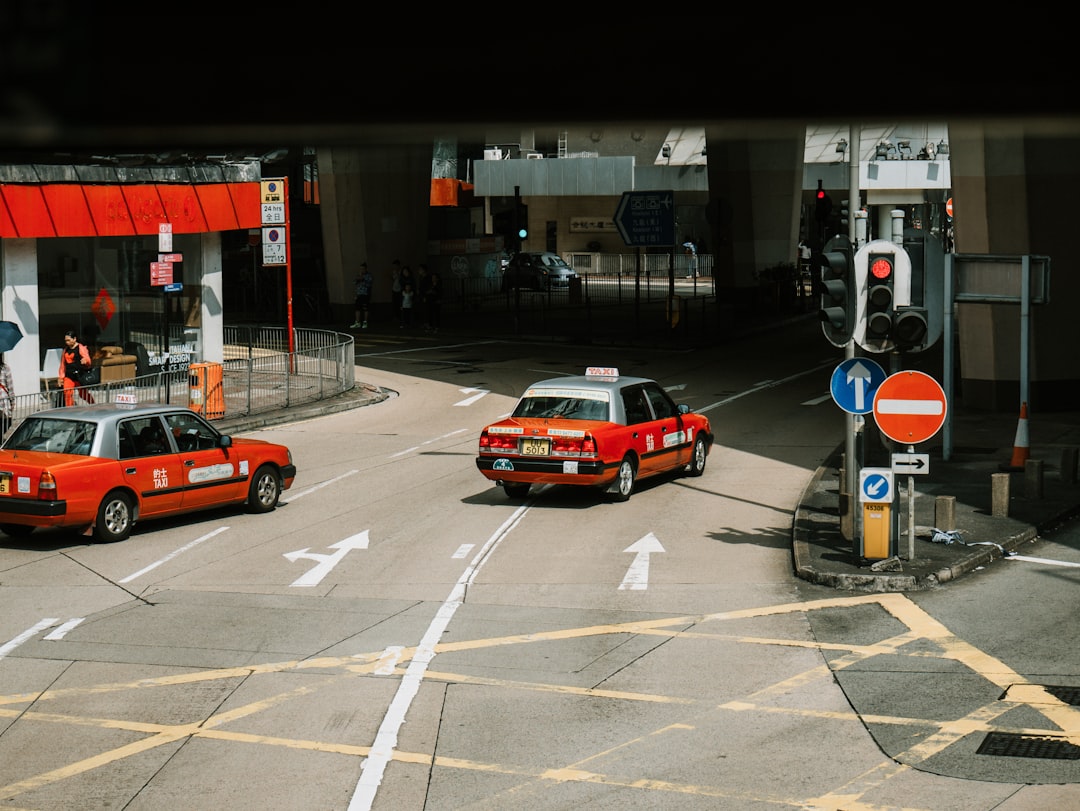 red sedan running near underpass