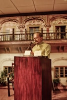 A close-up of a leader speaking passionately at a podium during a global policy forum.
