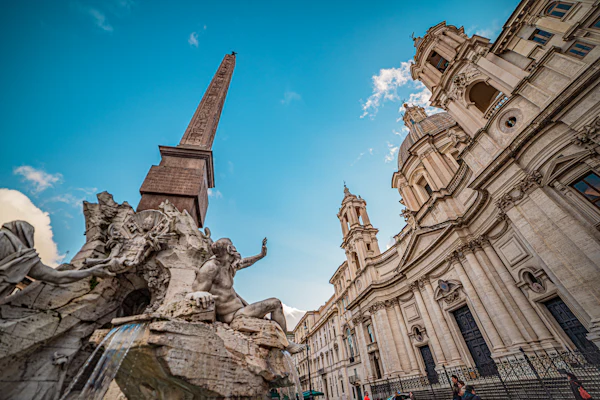 Fountain sculpture, obelisk and church façade in Piazza Navona, Rome