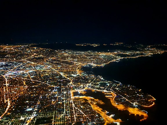 An aerial view of a city with digital connectivity lines.